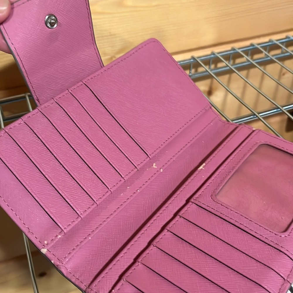 Fossil wallet. 2 tiny scratches as seen in photos. 7 inches long, 4 inches wide